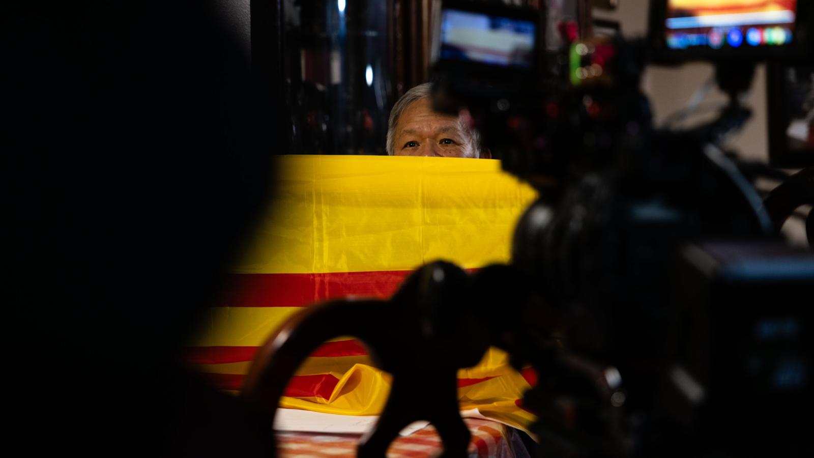 MSU Films takes a video of an interview in front of a flag