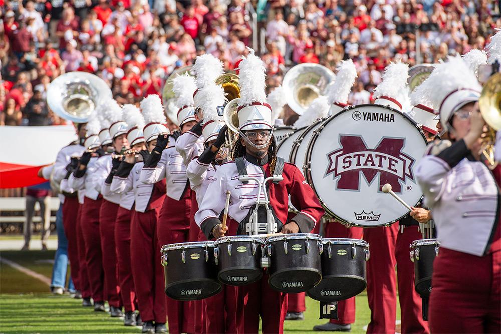 The MSU Famous Maroon Band drum line during a football game