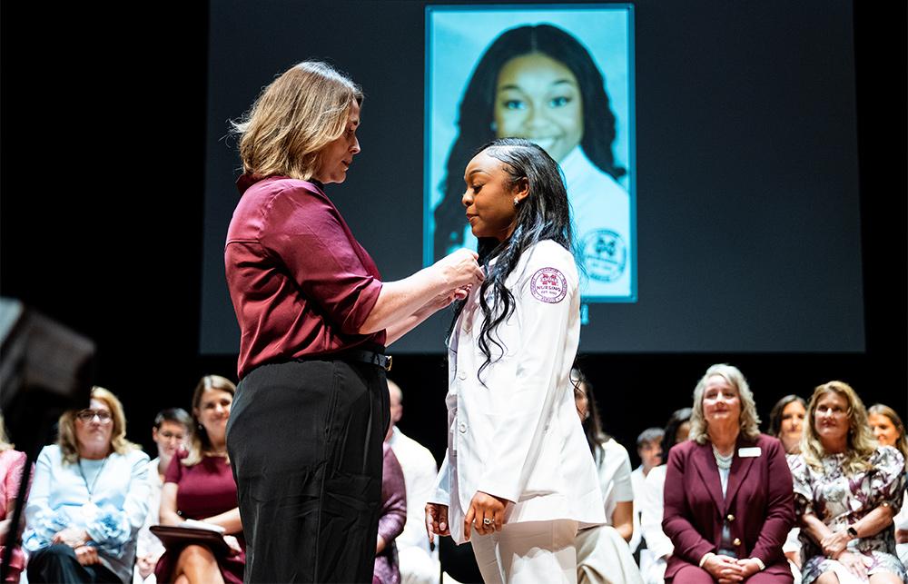 MSU Associate Dean and Master of Science in Nursing Program Director Kayla Carr pins Miriah Ford of Louisville, who completed her MSN degree this summer at MSU-Meridian.