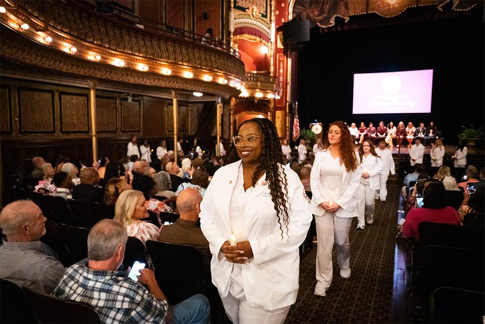 Jessyka Wansley of Newton leads as nursing students exit the historic MSU Riley Center following their pinning ceremony on graduation day.