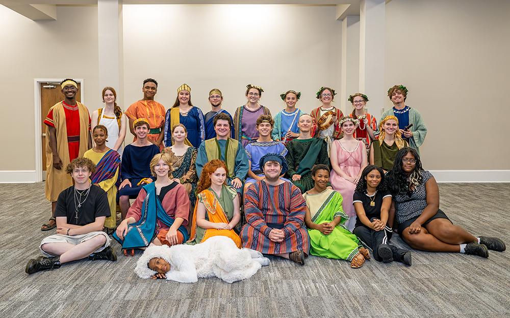 A group of Mississippi State student-actors pose in a group during play rehearsals.