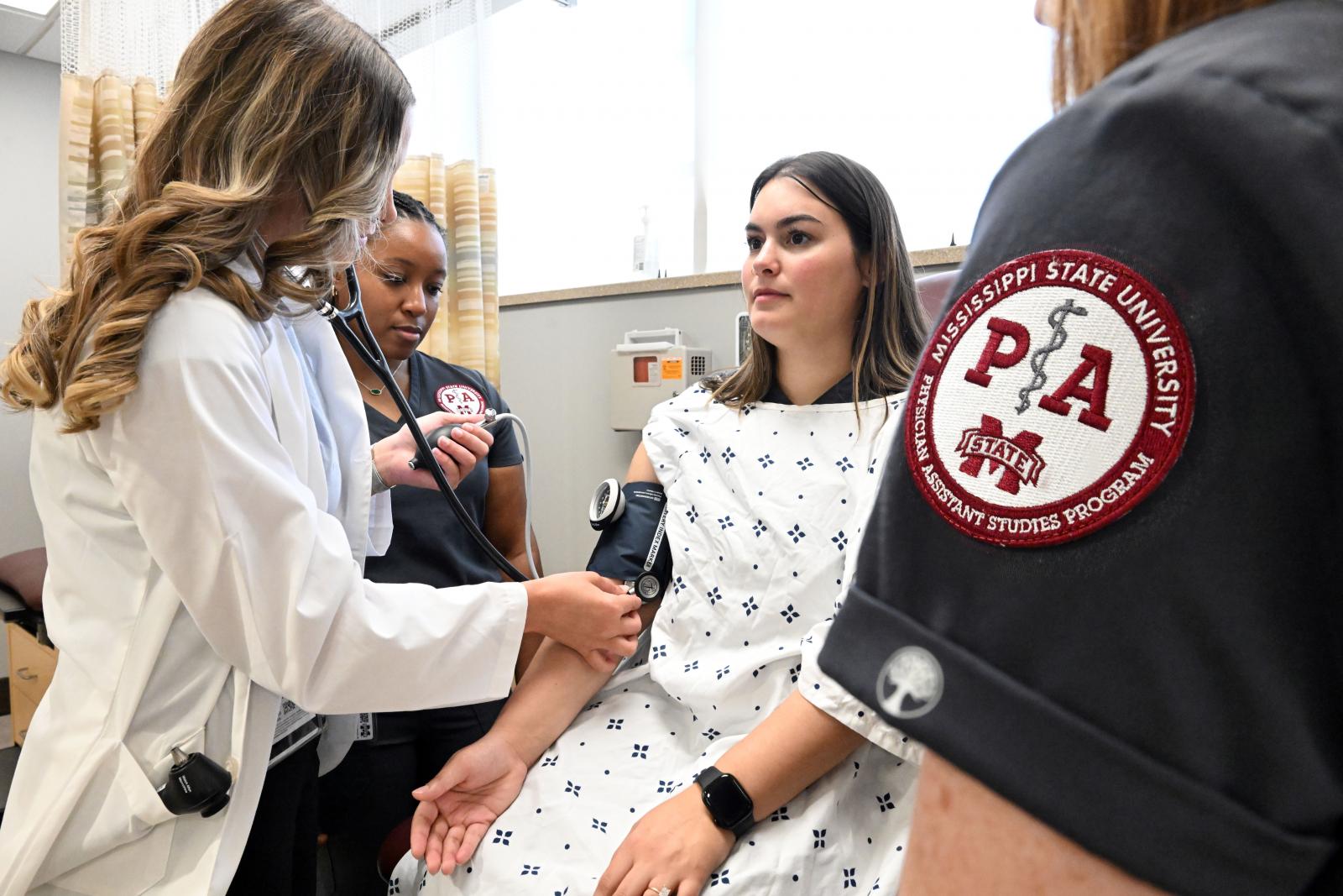 photo of Elise Latiolas doing blood pressure labs