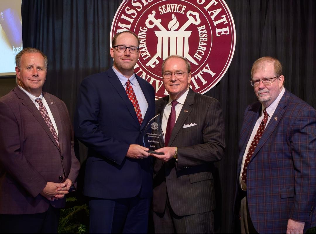 photo of MSU VPs and president with award winner Lorin Harvey