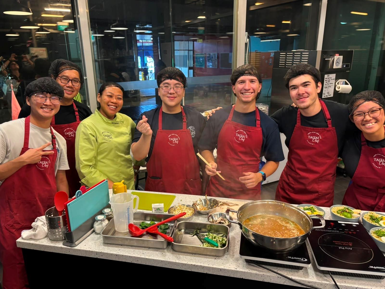Photo of Apollo Stafford with classmates taking a cooking class