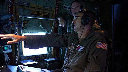 U.S. Air Force 2nd Lieutenant Andrew Wilson works on a Hurricane Hunters flight observing Hurricane Isaias as it approaches the Gulf Coast.
