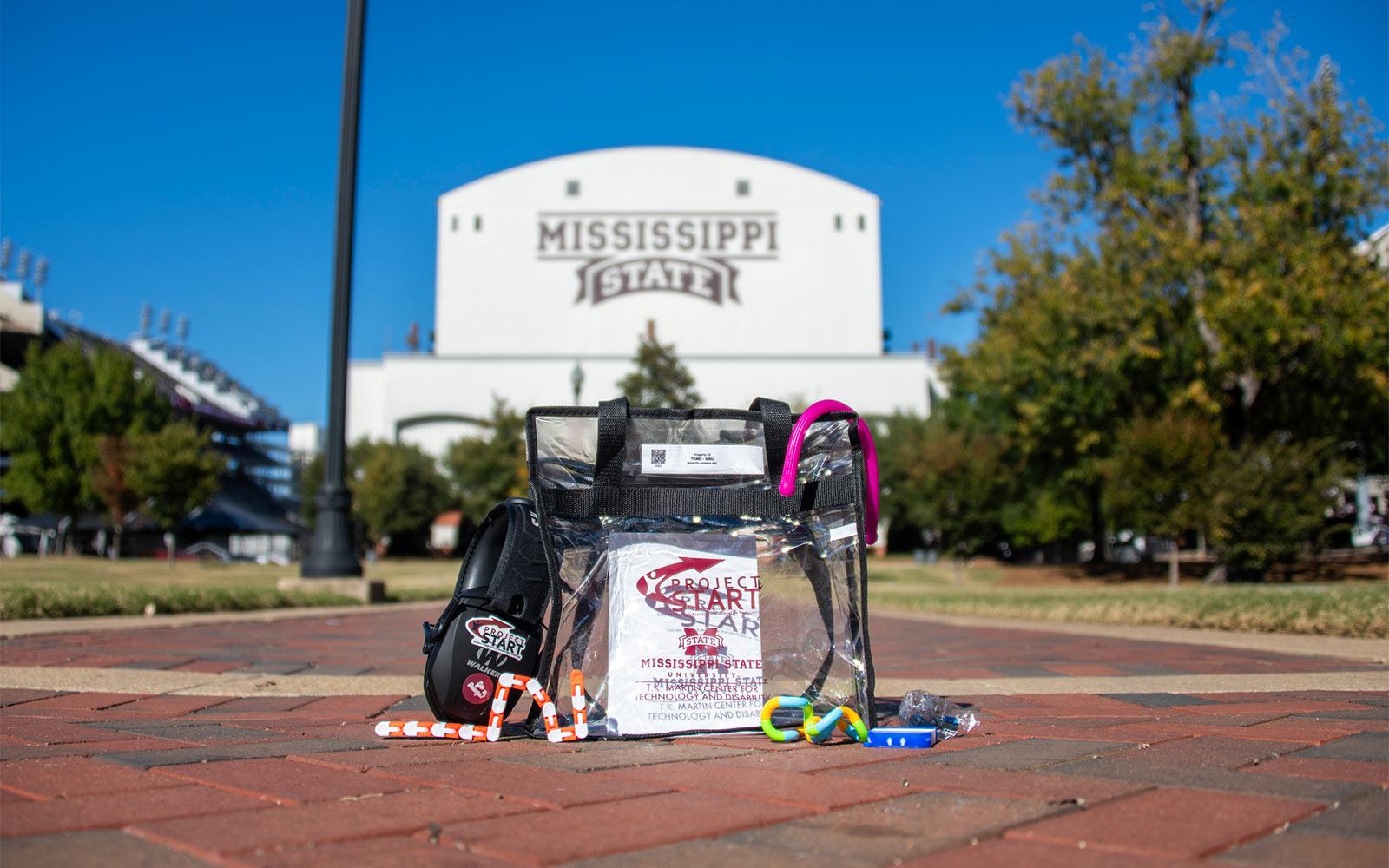 A sensory bag and its components sit on a walkway outside MSU's Davis Wade Stadium
